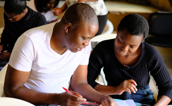 a-man-and-a-woman-looking-at-a-piece-of-paper