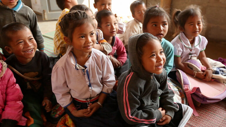 a-group-of-children-sitting-on-the-floor