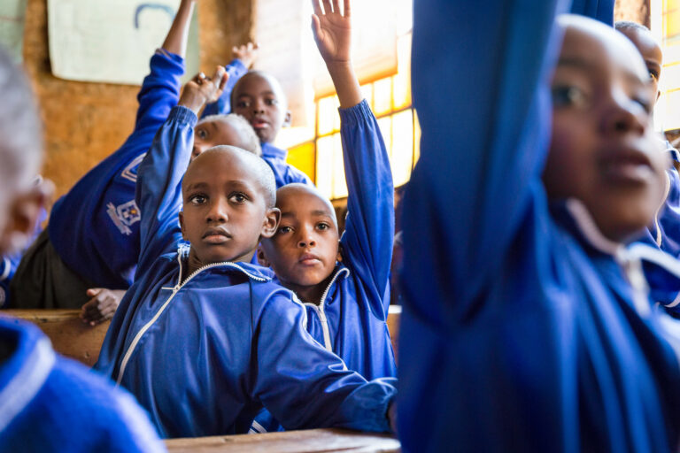 a-group-of-children-raising-their-hands