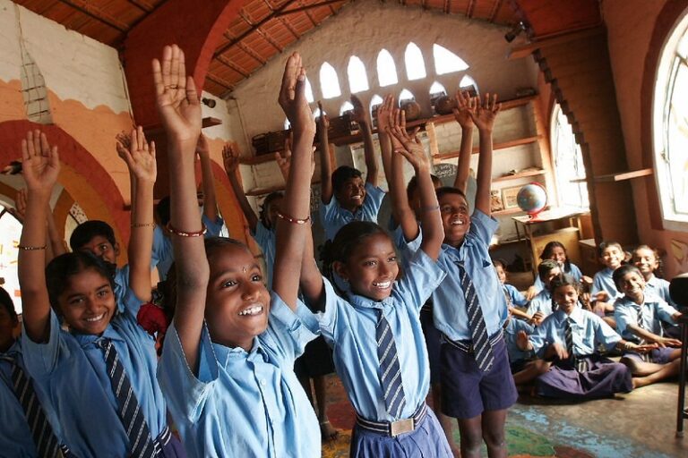 a-group-of-children-raising-their-hands