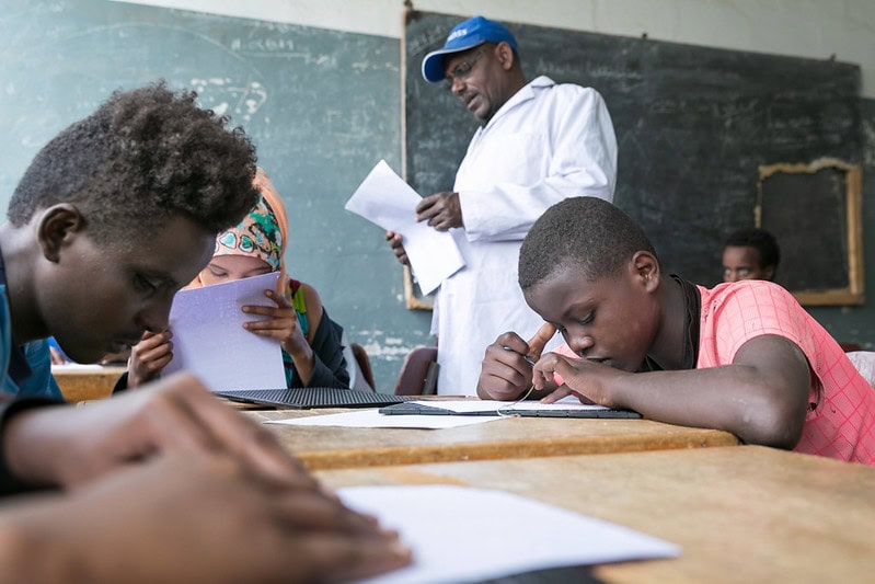 school children reading in braille